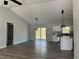 Spacious living room with vaulted ceiling, modern lighting fixtures, and sliding glass doors to the backyard at 20652 Sw Cardinal Ave, Dunnellon, FL 34431