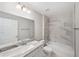 Well-lit bathroom with modern vanity, large mirror, and tiled shower at 207 Juniper Loop Cir, Ocala, FL 34480