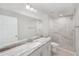 Modern bathroom with double vanity, large mirror, and sleek, tiled shower at 207 Juniper Loop Cir, Ocala, FL 34480