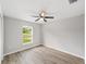 Comfortable bedroom with natural light, ceiling fan, and wood-look floors at 207 Juniper Loop Cir, Ocala, FL 34480