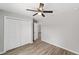Inviting bedroom with ceiling fan, wood-look flooring, and spacious closet at 207 Juniper Loop Cir, Ocala, FL 34480