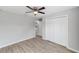Bright bedroom with ceiling fan, wood-look flooring, and large closet at 207 Juniper Loop Cir, Ocala, FL 34480