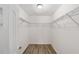 Walk-in closet featuring ample storage with wire shelving and wood-look flooring at 207 Juniper Loop Cir, Ocala, FL 34480