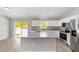Kitchen featuring stainless steel appliances, stone countertops, island, and access to the patio at 207 Juniper Loop Cir, Ocala, FL 34480