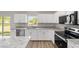 Kitchen featuring stainless steel appliances, stone countertops, and bright white cabinetry at 207 Juniper Loop Cir, Ocala, FL 34480