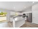 Bright kitchen featuring stainless steel appliances, stone countertops, an island and lots of light at 207 Juniper Loop Cir, Ocala, FL 34480