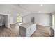 Bright, open-concept kitchen with island, modern countertops, and wood-look flooring at 207 Juniper Loop Cir, Ocala, FL 34480