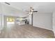 Spacious living room featuring hardwood floors, ceiling fan, and kitchen access at 207 Juniper Loop Cir, Ocala, FL 34480
