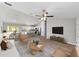 Open-concept living room featuring hardwood floors, a ceiling fan, and lots of natural light at 207 Juniper Loop Cir, Ocala, FL 34480