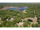 Aerial view of home near a large lake surrounded by mature trees at 21884 Sw 88Th Lane Rd, Dunnellon, FL 34431
