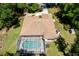 Aerial view of the screened in pool, lush landscaping and patio area at 21884 Sw 88Th Lane Rd, Dunnellon, FL 34431