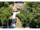 Aerial view of sprawling home surrounded by lush trees with a long driveway at 21884 Sw 88Th Lane Rd, Dunnellon, FL 34431