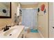 Bathroom featuring decorative floral decor, tile floors, shower with decorative curtain, and vanity with modern fixtures at 21884 Sw 88Th Lane Rd, Dunnellon, FL 34431