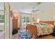 Bright bedroom with hardwood floors, a ceiling fan and a large window providing ample natural light at 21884 Sw 88Th Lane Rd, Dunnellon, FL 34431