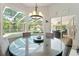 Bright breakfast nook with views of the pool and lanai through large windows at 21884 Sw 88Th Lane Rd, Dunnellon, FL 34431