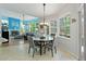 Cozy dining area with bright blue accent wall, fireplace, and views of the backyard at 21884 Sw 88Th Lane Rd, Dunnellon, FL 34431