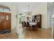 Elegant dining room with laminate floors, a stylish chandelier, and seating for eight guests at 21884 Sw 88Th Lane Rd, Dunnellon, FL 34431