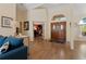 Inviting foyer with hardwood floors, a blue sofa and double doors leading into the home at 21884 Sw 88Th Lane Rd, Dunnellon, FL 34431