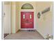 Bright red double doors with glass panes, a 'Welcome' sign and a decorative wreath accenting the entry at 21884 Sw 88Th Lane Rd, Dunnellon, FL 34431
