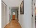 Hallway with hardwood floors and white trim leads to other rooms in the home at 21884 Sw 88Th Lane Rd, Dunnellon, FL 34431