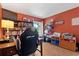 Well-lit home office with built-in bookshelves, a large window, and hardwood floors at 21884 Sw 88Th Lane Rd, Dunnellon, FL 34431