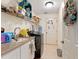 Functional laundry room with granite countertops, sink, and storage shelves above the washer and dryer at 21884 Sw 88Th Lane Rd, Dunnellon, FL 34431