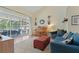 Comfortable living room with a sliding glass door to the lanai, vaulted ceiling, and hardwood floors at 21884 Sw 88Th Lane Rd, Dunnellon, FL 34431