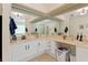 Main bathroom featuring dual sinks, a large mirror, and a soaking tub with shower at 21884 Sw 88Th Lane Rd, Dunnellon, FL 34431
