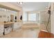 Spacious main bathroom with a soaking tub, glass-enclosed shower, and dual vanities at 21884 Sw 88Th Lane Rd, Dunnellon, FL 34431