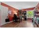 Functional home office with laminate floors, a desk, a bookshelf, and ample storage solutions at 21884 Sw 88Th Lane Rd, Dunnellon, FL 34431