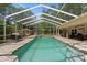 Inviting screened-in pool area with brick pavers and outdoor seating for relaxation and entertaining at 21884 Sw 88Th Lane Rd, Dunnellon, FL 34431