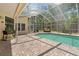 A delightful screened-in pool with brick pavers and comfortable seating for outdoor enjoyment at 21884 Sw 88Th Lane Rd, Dunnellon, FL 34431