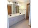 Bathroom features a double sink vanity with storage and tile floor at 2865 Se 37Th St, Ocala, FL 34471