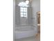 Bright bathroom showcasing a soaking tub beneath a window with elegant curtains at 2865 Se 37Th St, Ocala, FL 34471