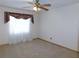 Cozy bedroom with natural light streaming through the window and a ceiling fan at 2865 Se 37Th St, Ocala, FL 34471