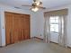 Bedroom showing carpet, window with curtains, closet, and ceiling fan at 2865 Se 37Th St, Ocala, FL 34471