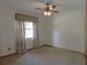 Bedroom showing carpet, window with curtains, and ceiling fan at 2865 Se 37Th St, Ocala, FL 34471