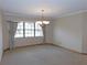 Elegant dining room featuring a chandelier, large window, and neutral decor at 2865 Se 37Th St, Ocala, FL 34471