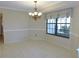 Dining room featuring tile floor, chair rail and elegant chandelier at 2865 Se 37Th St, Ocala, FL 34471