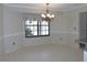 Dining room featuring tile floor, chair rail and elegant chandelier at 2865 Se 37Th St, Ocala, FL 34471