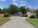 Long driveway leading to a home with a well-manicured lawn and mature landscaping at 2865 Se 37Th St, Ocala, FL 34471