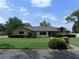Street view of well landscaped single story home with brick and neutral siding and manicured front lawn at 2865 Se 37Th St, Ocala, FL 34471