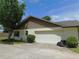 Exterior home view with a two-car garage and low-maintenance landscaping at 2865 Se 37Th St, Ocala, FL 34471
