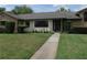 Charming single-story home with lush lawn, mature palm tree, and inviting front entrance at 2865 Se 37Th St, Ocala, FL 34471