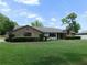 Well-maintained home with lush green lawn, trimmed hedges, and a welcoming brick exterior at 2865 Se 37Th St, Ocala, FL 34471