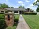Charming home with brick accents, a neatly maintained lawn, and a welcoming front walkway at 2865 Se 37Th St, Ocala, FL 34471