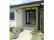 Inviting front porch with decorative door, white trim, and landscaped garden area at 2865 Se 37Th St, Ocala, FL 34471