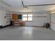 Garage interior with workbench, storage, and natural light from window at 2865 Se 37Th St, Ocala, FL 34471