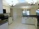 Well-lit kitchen area with white cabinets, modern appliances, and an adjoining breakfast bar at 2865 Se 37Th St, Ocala, FL 34471