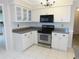 Updated kitchen featuring white cabinetry, stainless steel appliances, and ample counter space at 2865 Se 37Th St, Ocala, FL 34471